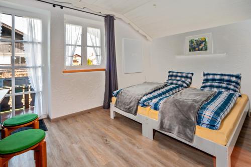 a bedroom with two beds and a table and chairs at Appartement Braun 3 in Bolsterlang