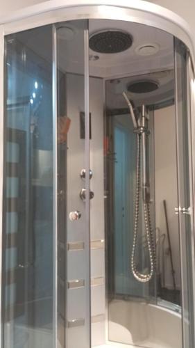 a shower with a glass door in a bathroom at u EWY Borne Militaria 2 pokoje z balkonem dla 3 osób- Parking w cenie pobytu Kody przed przyjazdem w wiadomości od operatora in Borne Sulinowo