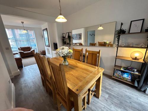 a dining room with a wooden table and chairs at House - Sleeps 6 Pet Friendly & Courtyard in Weymouth