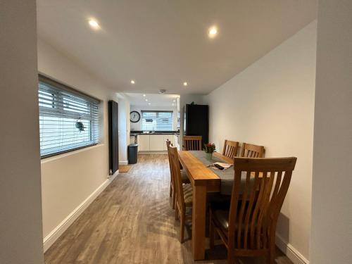 a dining room and kitchen with a table and chairs at House - Sleeps 6 Pet Friendly & Courtyard in Weymouth
