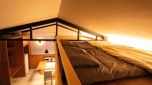 a bedroom with a bunk bed in a room at Hotel Re:Plug in Kochi