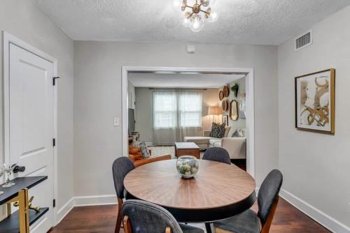 a living room with a wooden table and chairs at Modern 2 BR Condo - 2 block from San Marco in Jacksonville