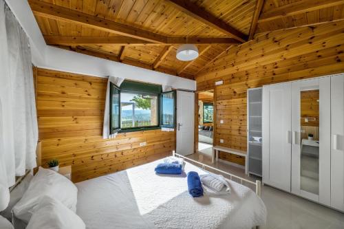 a bedroom with wooden walls and a large bed at Sofia's Place in Heraklio