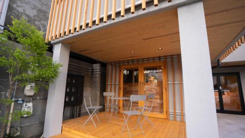 a patio with chairs and a table on a house at Hotel Re:Plug in Kochi