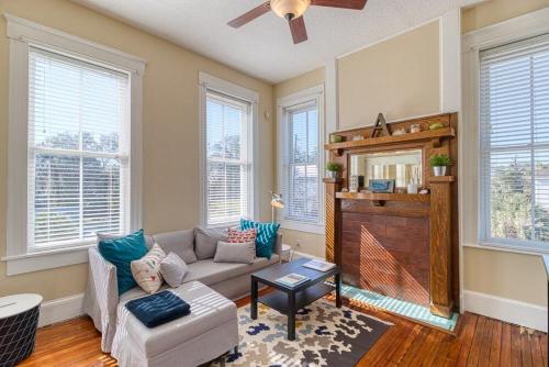 a living room with a couch and a tv at Open & Bright - 5 min drive to TIAA Bank field in Jacksonville