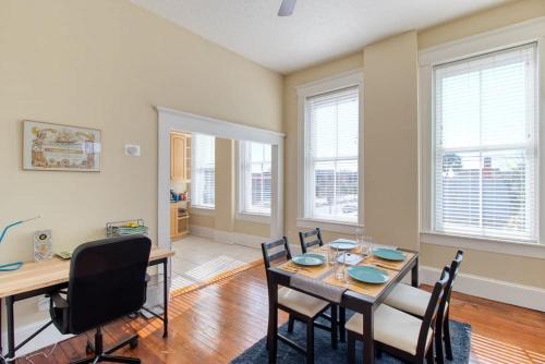 a dining room with a table and chairs at Open & Bright - 5 min drive to TIAA Bank field in Jacksonville