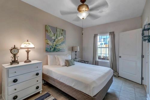 a bedroom with a bed and a dresser and a window at Charming 1st floor apt in the heart of Springfield in Jacksonville