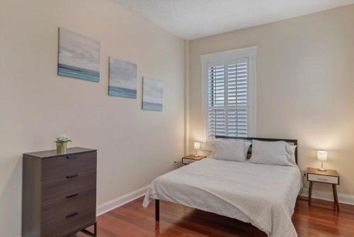 a bedroom with a bed and a dresser and a window at LT Stay Discounts! Cozy 2 BR Apt - Pet Friendly! in Jacksonville