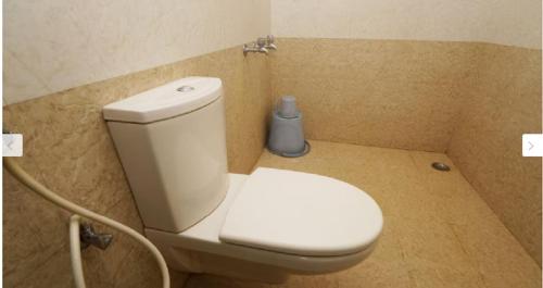 a bathroom with a white toilet in a room at HOTEL BHARANI in Kanyakumari