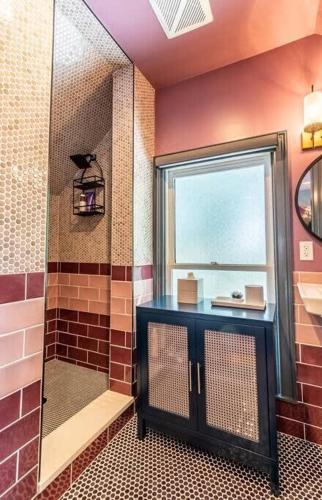 a bathroom with a shower with a glass door at Studio loft w pool spa & gardens near downtown in Jacksonville