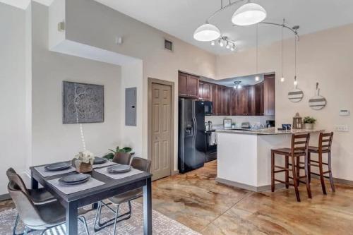 a kitchen and living room with a table and chairs at Modern, Insta-Worthy 2B Townhome in Walkable Springfield! in Jacksonville