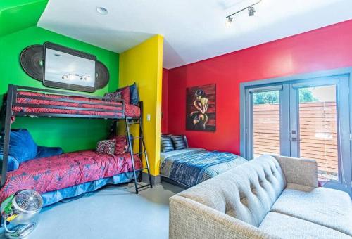 a room with two bunk beds and a couch at Unique studio w pool spa & gardens near downtown in Jacksonville