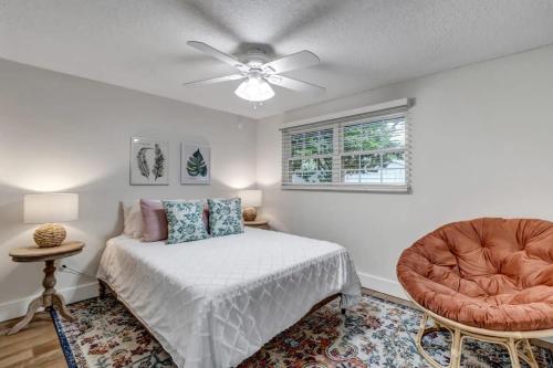 a bedroom with a bed and a ceiling fan at Spacious Home w Pool-Tucked Away in Jax Beach in Jacksonville Beach