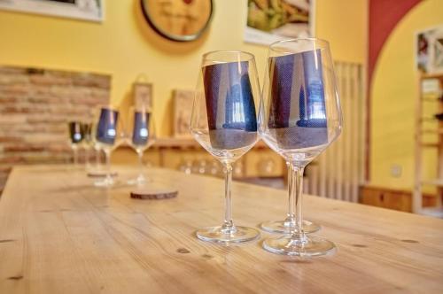 a row of wine glasses sitting on a wooden table at La Kasilla de Viana by Clabao in Viana