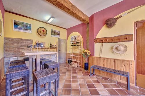 a restaurant with a bar and stools in a room at La Kasilla de Viana by Clabao in Viana