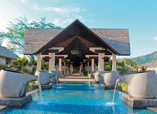 a resort with a pool with fountains at STORY Seychelles in Beau Vallon