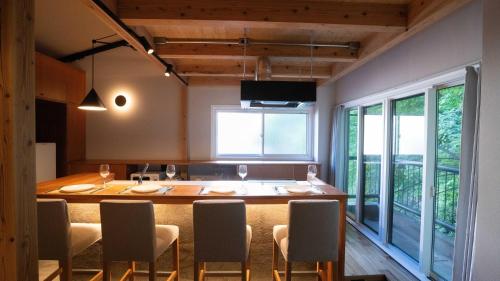 a dining room with a large table and chairs at Hotel Re:Plug in Kochi