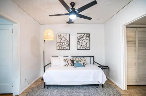 a bedroom with a bed with a ceiling fan at Charming Riverside Retreat 1 1 - Near 5 Points #4 in Jacksonville