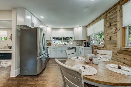 a kitchen with a table and a refrigerator at Cozy Riverside Villa - Walkable to Bars & Restaurants in Jacksonville