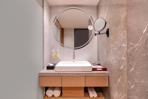 a bathroom with a sink and a mirror at Lemon Tree Premier, Malad, Mumbai in Mumbai