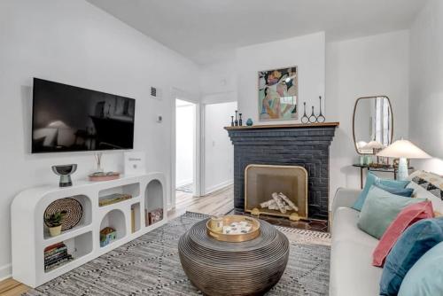a living room with a couch and a fireplace at Fourth House - Eclectic and fun 1BR in SPR in Jacksonville