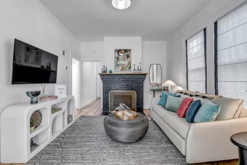 a living room with a couch and a fireplace at Fourth House - Eclectic and fun 1BR in SPR in Jacksonville