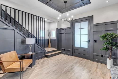 a living room with a staircase and a door at Farmhouse chic in San Marco - 5 min to downtown in Jacksonville