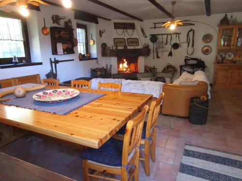 a wooden table and chairs in a living room with a fireplace at Baita - Chalet tra Pinzolo e Madonna di Campiglio in Madonna di Campiglio