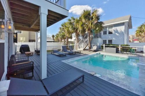 a deck with a swimming pool on a house at Slow Pace Beach Living - Pool - Steps from Beach in Jacksonville Beach