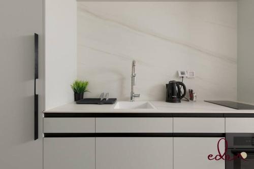 a kitchen with a sink and a white counter top at סוויטה מעוצבת עם נוף מדהים לים - By Edomlux in Eilat