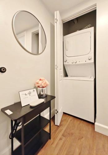 a desk with a mirror next to a refrigerator at Fun Cozy Apts - 1 25 Mile Walk to TIAA Bnk Fld in Jacksonville