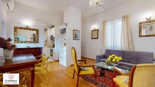 a living room with a couch and a table at Fortezza apartment in Florence