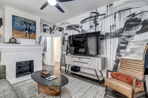 a living room with a tv and a fireplace at Contemporary Apartment - 5 Min To TIAA Bank Field! in Jacksonville