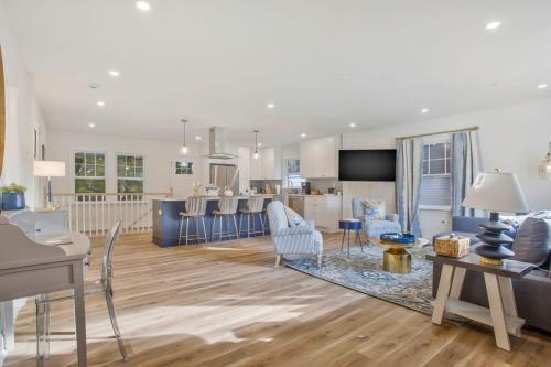 a living room and kitchen with blue and white furniture at Stylish + fresh bungalow 2 blocks from N-MC Stadium in Annapolis
