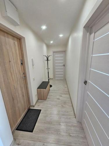 a hallway with a room with a door and a floor at Gražus ir ramus butas jonavoje in Jonava