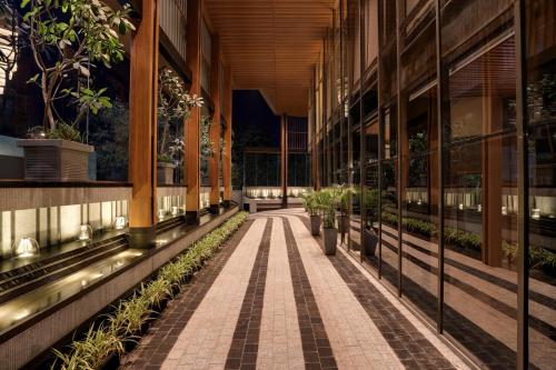 an empty hallway of a building with potted plants at Lemon Tree Premier, Malad, Mumbai in Mumbai