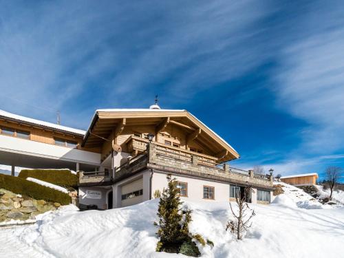 a house in the snow with a roof at Sunlit Apartment near Ski Area in Hollersbach im Pinzgau in Hollersbach im Pinzgau