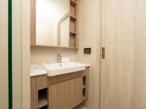a bathroom with a sink and a mirror at Family 2bd apartments in Laguna SkyPark in Bang Tao Beach