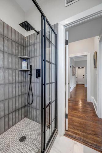 a bathroom with a shower with a glass door at Renovated Apt - Blocks from Shoppes of Avondale in Jacksonville