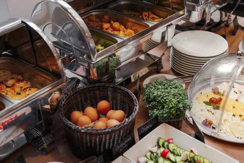 a buffet with eggs in a basket and other food at Continental Hotel in Odesa