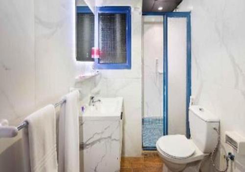 a white bathroom with a toilet and a sink at شقق الفخامة حي السلامة in Jeddah