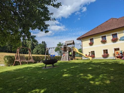 a yard with a playground and a swing at Biohof Bernhard in Unterweissenbach