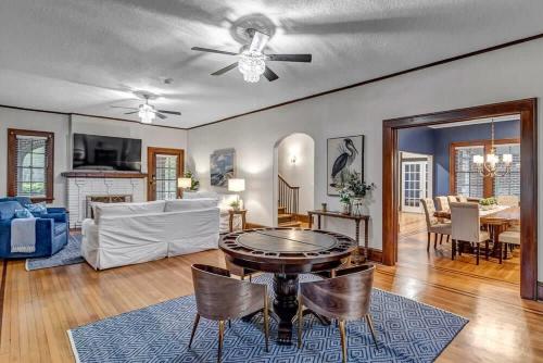 a living room with a ceiling fan and a table at Stunning and Cozy 4BR in Historic Avondale in Jacksonville
