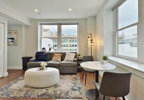a living room with a couch and a table at Fun Cozy Apts - 1 25 Mile Walk to TIAA Bnk Fld in Jacksonville