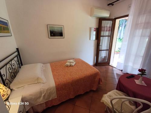 a bedroom with a bed with a towel on it at Agriturismo Bio Pian Dei Casali in Saturnia