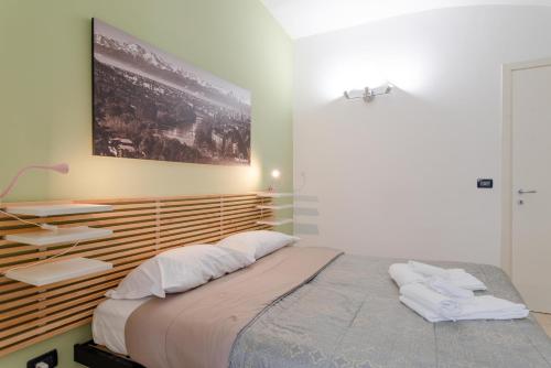Giường trong phòng chung tại Corte d'Appello Rooms
