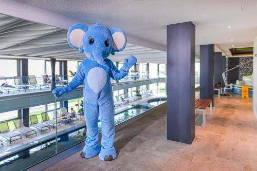 a large blue stuffed elephant standing on the floor of a building at Hotel Helikon, Keszthely in Keszthely