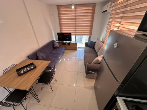 a living room with a couch and a table at Kyrenia center penthouse residence apartment in Kérynia