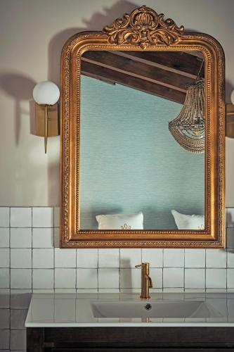a mirror over a sink in a bathroom at Casa Palacio Reina de Tardajos in Vinuesa