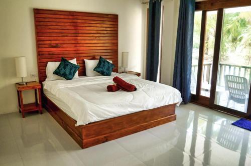 a bedroom with a bed with a red object on it at Seaside Sanctuary Bungalows in Ko Lanta